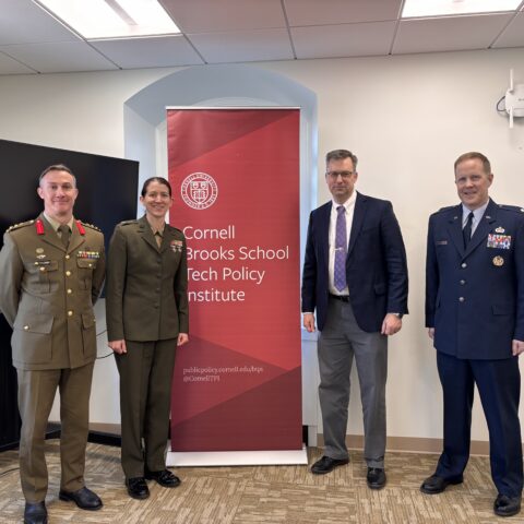 US army officers in front of poster